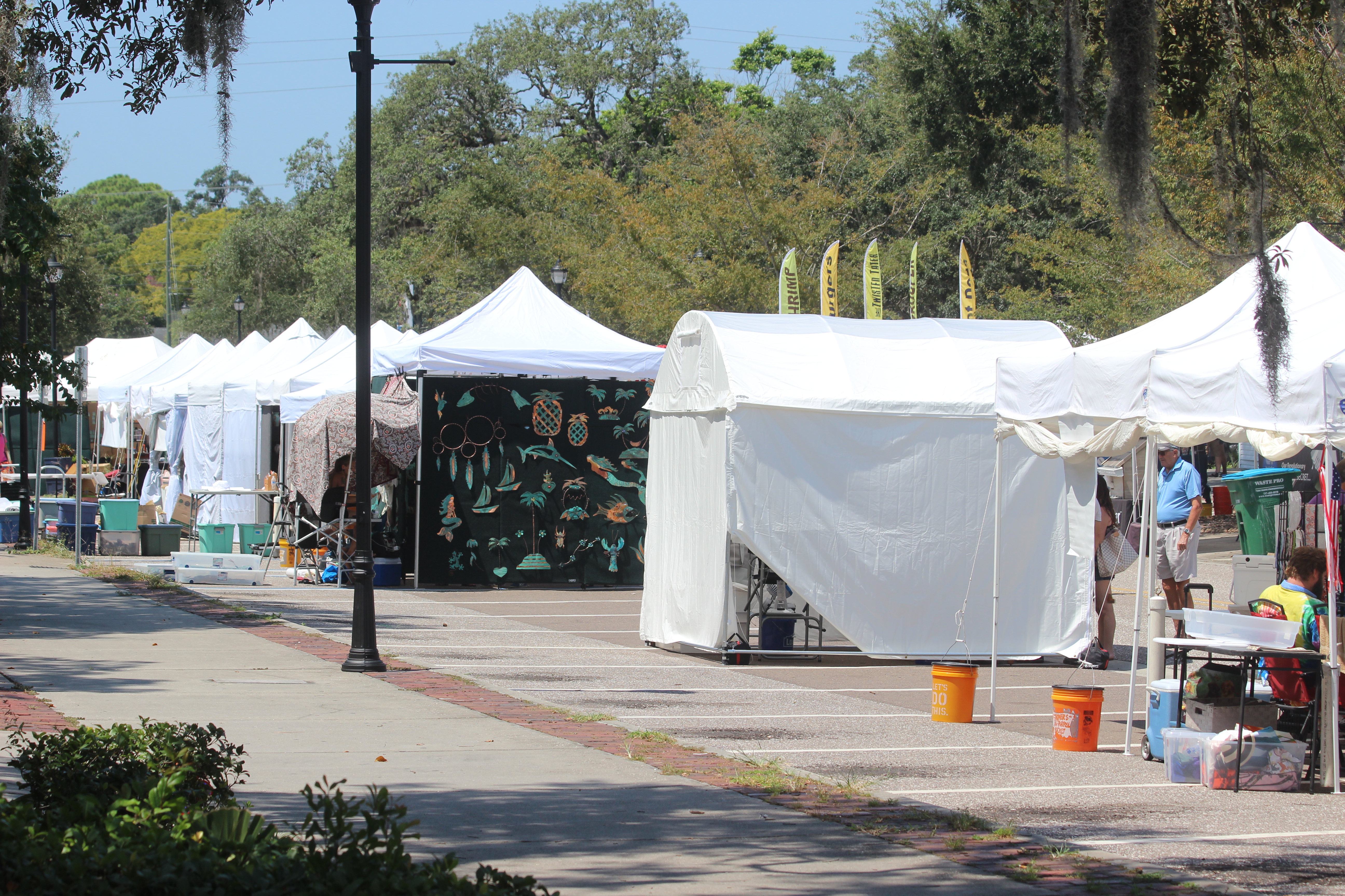 White vendor tents lined up at an outdoor art festival in Palm Harbor