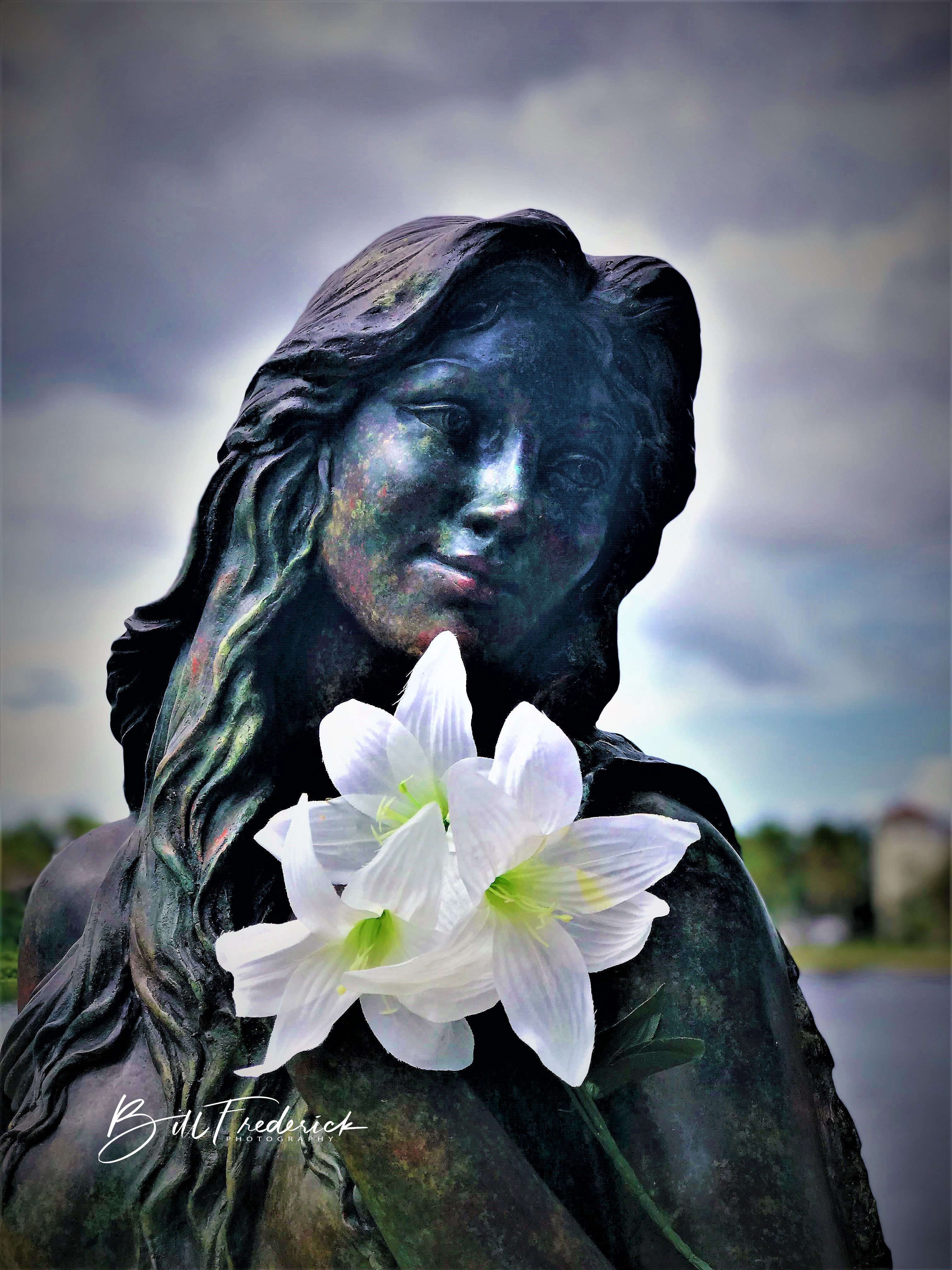 Bronze statue with white lily near the Tarpon Springs waterfront