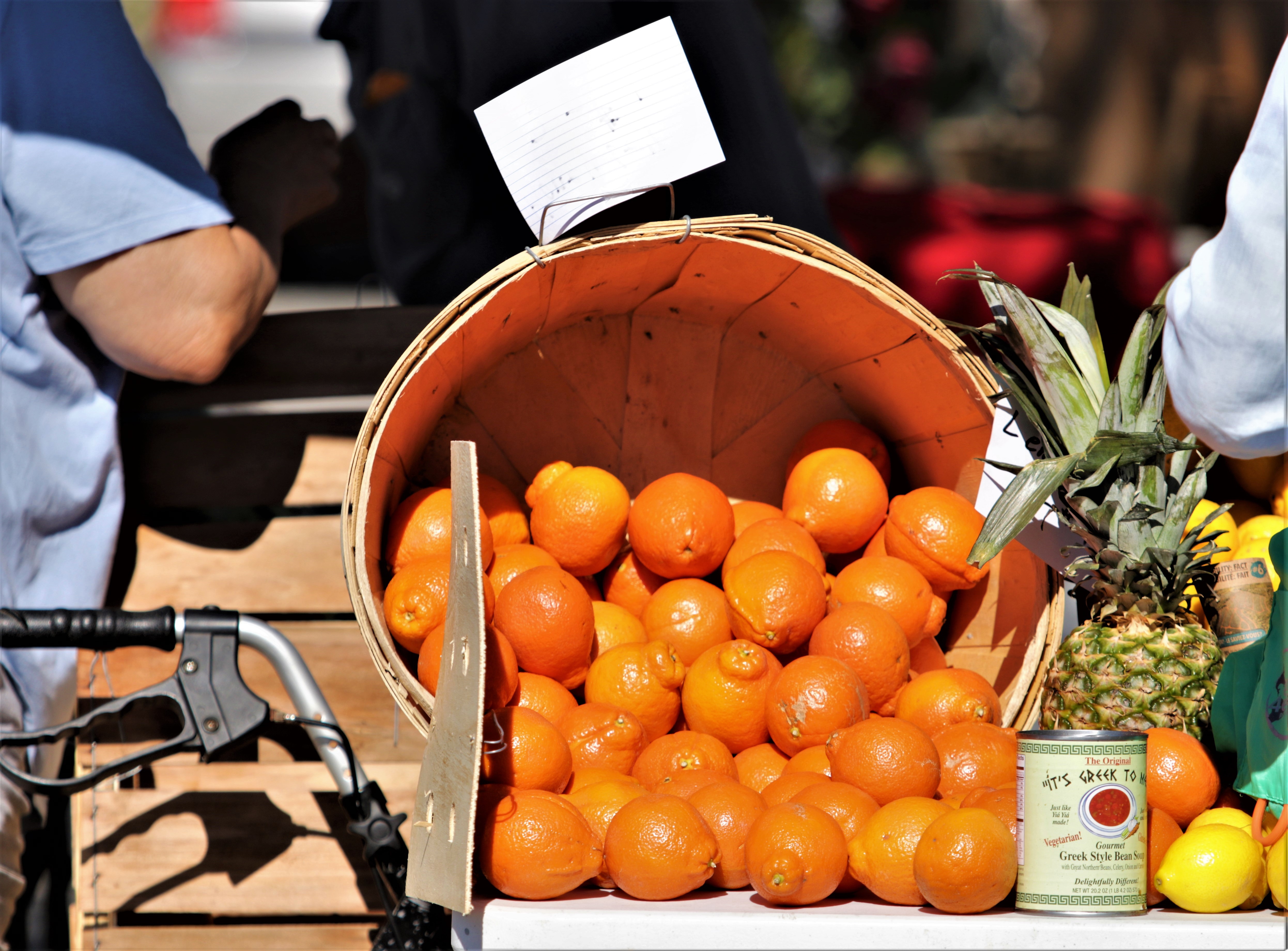 Basket of oranges and pineapples at a farmers market